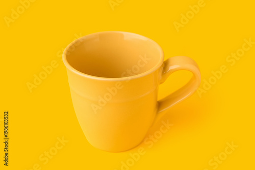 Yellow ceramic cup on color...