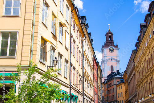 Narrow street in Gamla Stan Old Town Stockholm with Storkyrkan church tower, Sweden