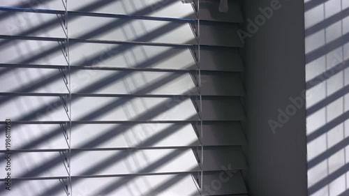 Venetian blinds window slats string in sunlight shadows 