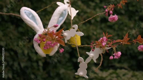 Easter bunny ears and easter decorations on blossom tree