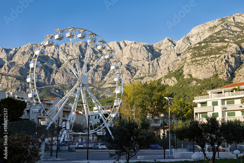 Ferris wheel in front of a mountain in the city center of Makarska on the Riviera, in Dalmatia in late summer