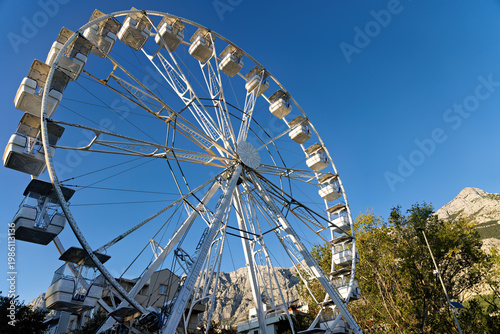 Ferris wheel in front of a mountain in the city center of Makarska on the Riviera, in Dalmatia in late summer
