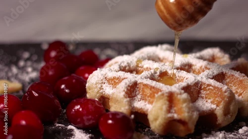 Topping honey waffles with ripe cranberries