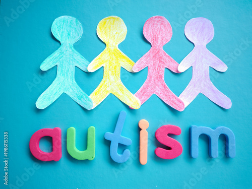 Autism Awareness Concept with Colorful Paper People Cutouts and Lettering on Blue Background – Symbol of Neurodiversity, Inclusion, and Community Support

