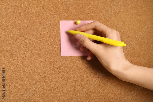 Young woman writing on stic...