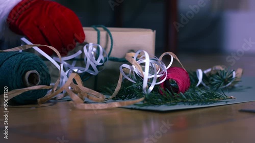 Christmas gift with wrapping ribbon and string green background