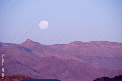 Golden dunes rise like waves frozen in time, stretching endlessly under a sky painted with soft pastels, where solitude and silence reveal the raw soul of Namibia’s desert.	
