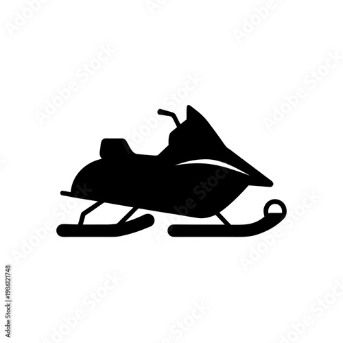 Snowmobile with rider in a crouched position on flat terrain