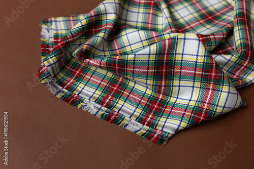 fabric with a checkered pattern on a brown background