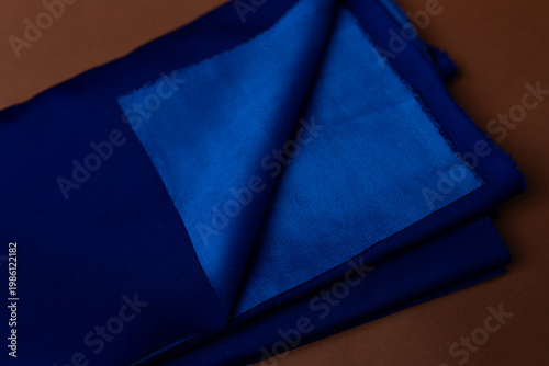 blue double-sided knitted fabric on a brown background