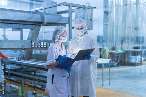 Quadro em tela Food and manufacturing researchers oversee seafood production lines in tightly controlled factories where machinery is used to produce and cook food before it is shipped out