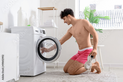 Young man in underpants put...