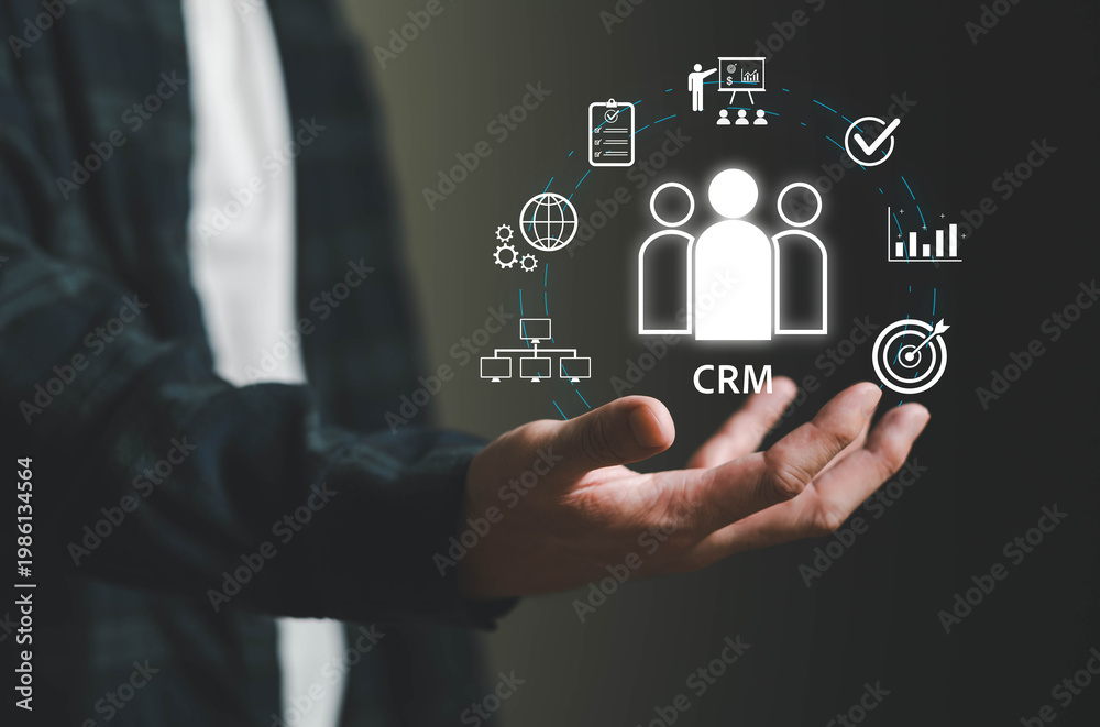 Obraz premium Hand presenting Customer Relationship Management concept with digital icons for analytics, sales, marketing, and customer data, representing business strategy, customer engagement, and data-driven.