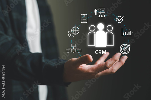 Hand presenting Customer Relationship Management concept with digital icons for analytics, sales, marketing, and customer data, representing business strategy, customer engagement, and data-driven.