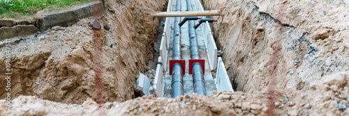 New pipes laying in an open trench, representing ongoing groundwork and utility installation at a construction site