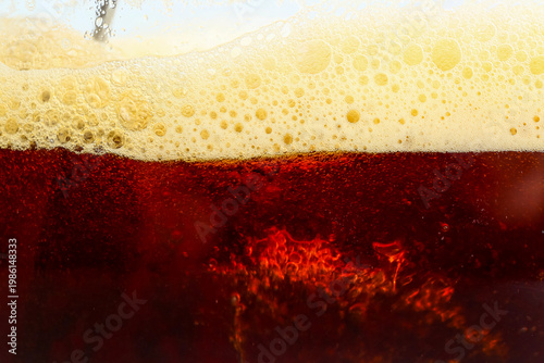 Dark beer with foam as back...
