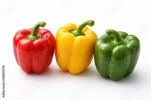Vibrant Capsicums: Three colorful capsicums in red, yellow, and green, arranged against a clean backdrop, offer a striking image of fresh produce and culinary potential.