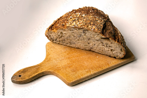 Healthy dark wheat wholemeal bread cut on wooden board