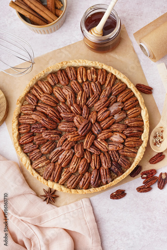 Tasty pecan pie on light ba...