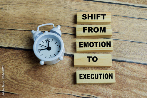 Concept of text shift from emotion to execution on wooden blocks. For transition to a productive, action-oriented mindset