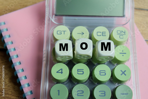 Concept of text MOM - Month Over Month Growth on wooden blocks. For accounting performance