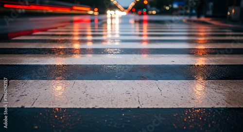 Wet pedestrian crossing at night with city traffic lights reflection.