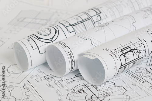 paper engineering drawings of industrial parts and mechanisms