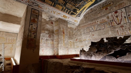 Broken stone sarcophagus of an ancient Egyptian pharaoh Ramesses inside a royal burial chamber of royal tomb KV 9, Valley of the Kings, Luxor, Egypt, with vivid hieroglyphic murals on walls.