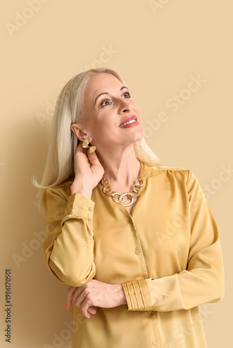 Mature blonde woman on beig...