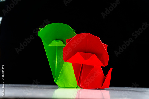Bright colorful origami paper dogs  on a white surface. Concept of diversity, teamwork, and family represented by colorful paper figures.
