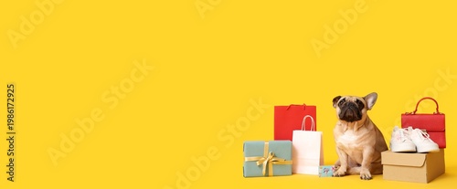 Cute bulldog with gift card, present and purchases on yellow background with ...