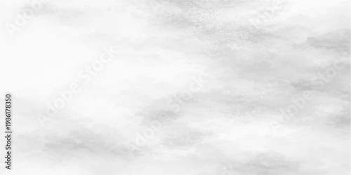 Fluffy white cirrus clouds drift across a beautiful clear blue sky on a bright sunny summer day, creating a peaceful nature cloudscape with a soft light texture in the atmosphere