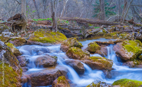 small river rushing over a stones in the mountain canyon