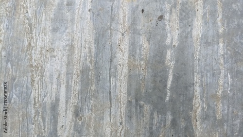 Weathered concrete wall with vertical water stains texture. Aged concrete wall with natural vertical water stains and mineral streaks, ideal for grunge backgrounds