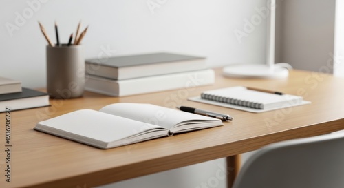 Minimalist home office desk with open notebook and books for study and work, modern workspace