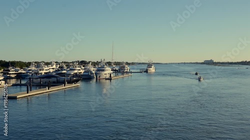Wide view of marina with boats on calm water in West Palm Beach