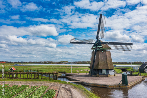 A bird's-eye view of a landscape in North Holland with a typical windmill.