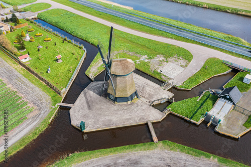 A bird's-eye view of a landscape in North Holland with a typical windmill.