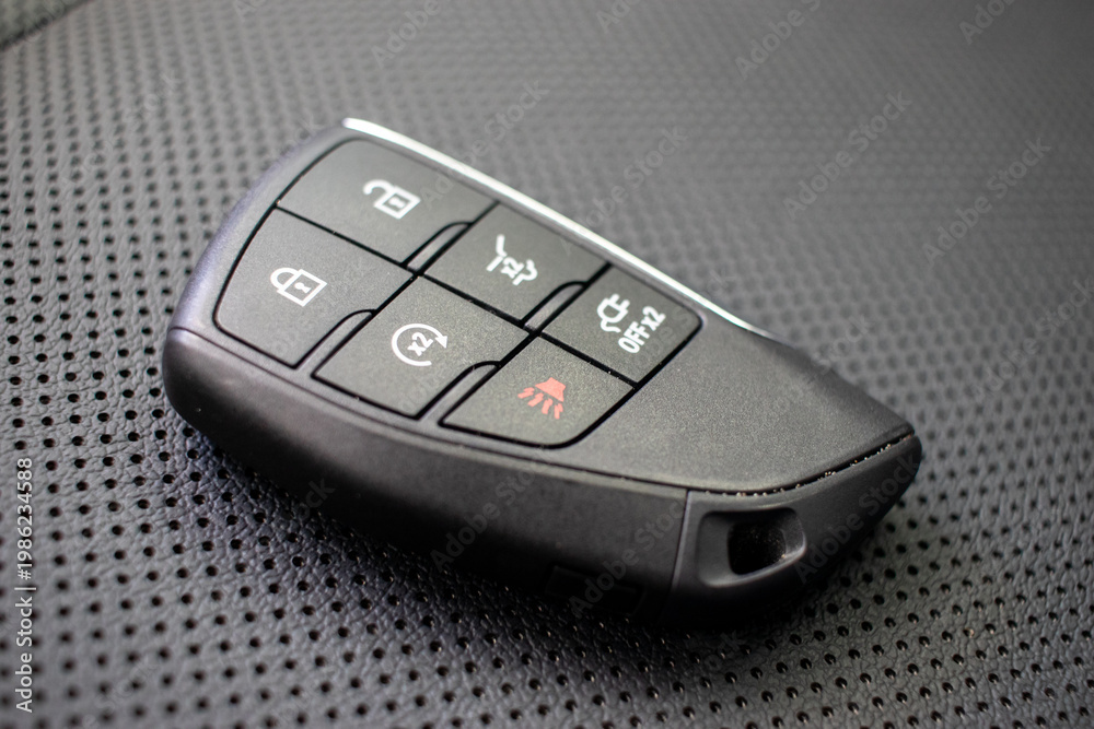 Obraz premium Automotive key with proximity sensor on textured surface.
