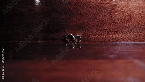 Slow Motion Close-Up of Rings Spinning and Stopping with Dramatic Lighting