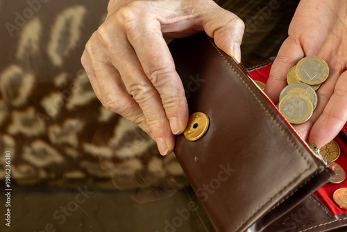 hand putting euro coins into wallet