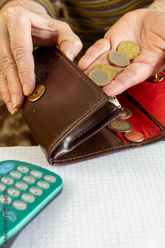 hand putting euro coins into wallet and copy space