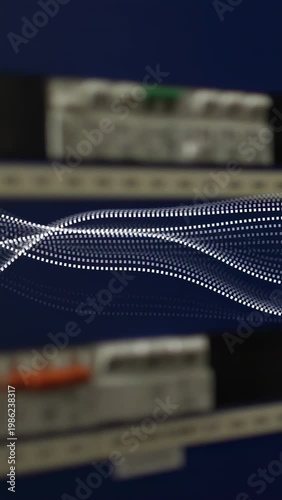 Vertical video: Play, dotted wave undulating and settling on DIN rail panel for electrical testing