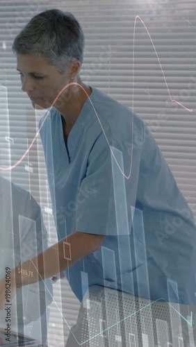 Vertical video: Nurse leaning over tablet, pointing as health graphs showing, doctor watching scope
