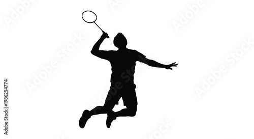 Silhouette of a badminton player in mid air preparing to strike