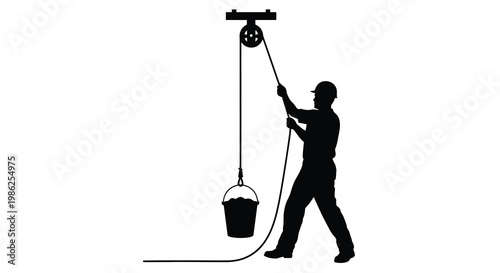 Silhouette of a construction worker operating a pulley system with a bucket