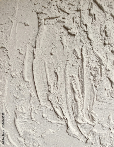 Imperfect cement plaster wall, uneven surface detail, construction material
