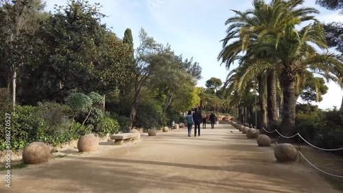 Walking Through Park Guell Barcelona POV. Walking through Park Guell in Barcelona. Iconic Gaudi park and major tourist attraction in Spain.