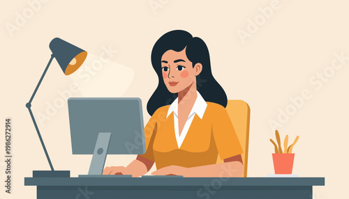woman sitting at desk with computer and lamp working.