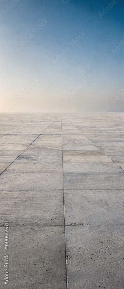 Fototapeta premium An abandoned runway in a desert landscape with a clear blue sky above.